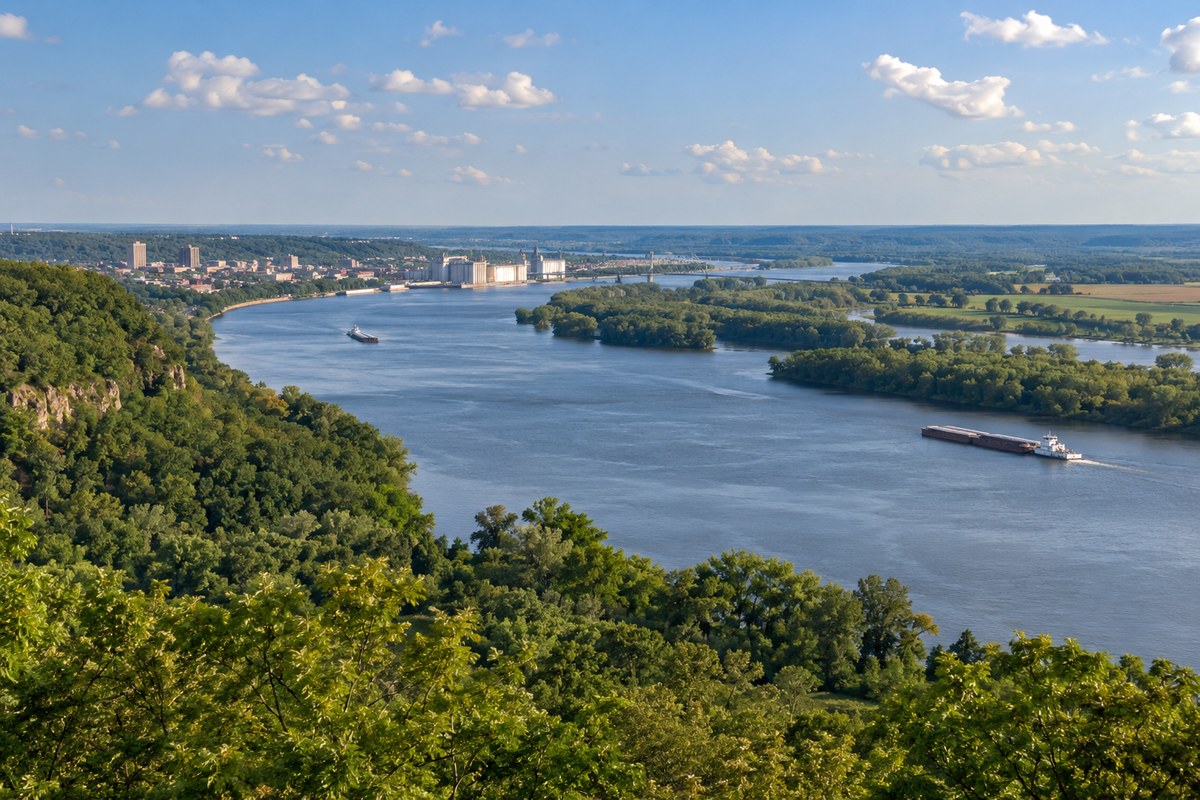 Illinois River Valley near Peoria with barges, a distant bridge and wooded bluffs